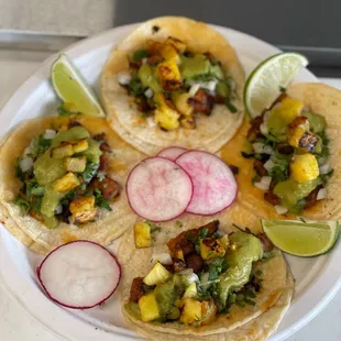 a variety of tacos on a plate