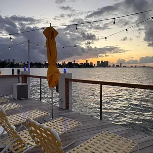 lounge chairs and umbrellas overlooking the water