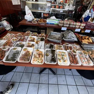 a table full of trays of food
