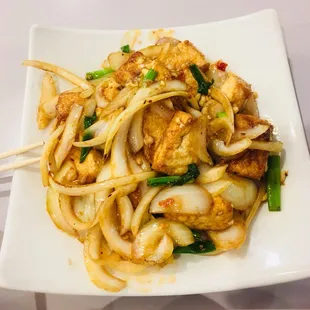 a plate of noodles and tofu