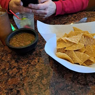 Chip &amp; salsa. Titos &amp; 7up. The hubs hands &amp; phone.