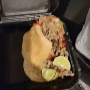 3 carne tacos slide out the the side
