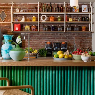 a counter with a variety of fruits and vegetables on it