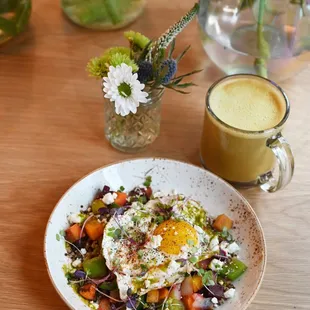 a plate of salad and a glass of orange juice