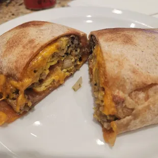a burrito cut in half on a plate