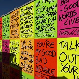 a colorful wall with writing on it