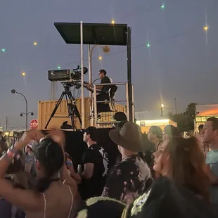 a man on a stage surrounded by people