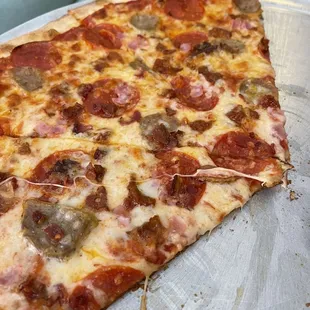 a slice of pepperoni and sausage pizza