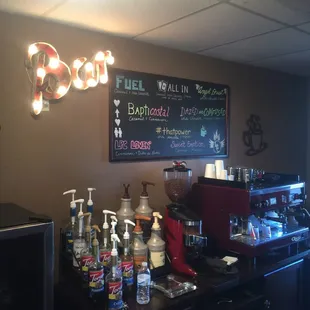 a coffee bar with a chalkboard