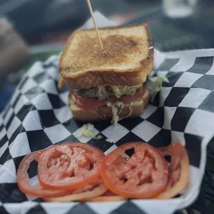 a grilled sandwich with tomatoes