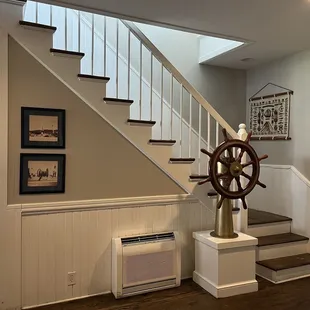 a staircase with a ship wheel on it