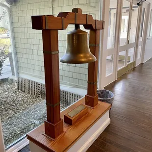 Historic bell displayed in hallway just inside front entrance to restaurant