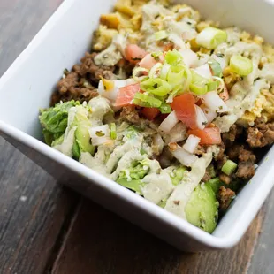 a bowl of food on a wooden table