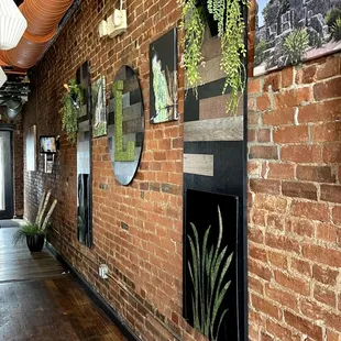 a brick wall with plants on it