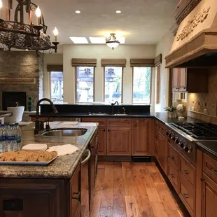 a kitchen with wood cabinets and granite countertops