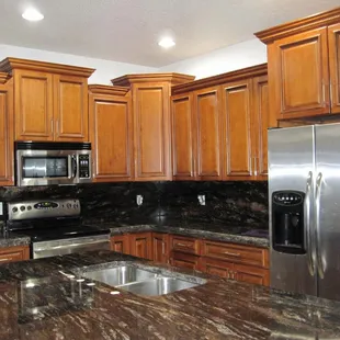 a kitchen with granite countertops and stainless steel appliances