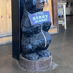 a bear holding a sign
