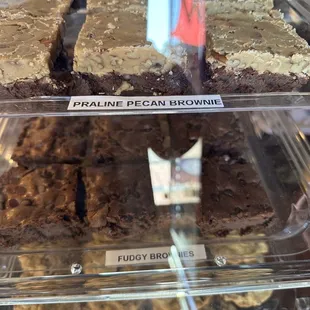 a variety of brownies in a display case