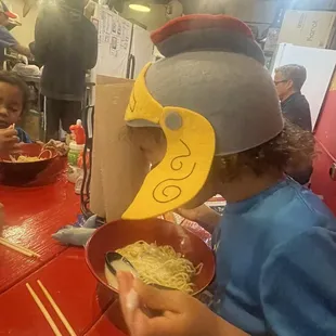 When the noodles are so delicious, the hat is a distant memory!