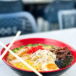 a bowl of ramen with chopsticks