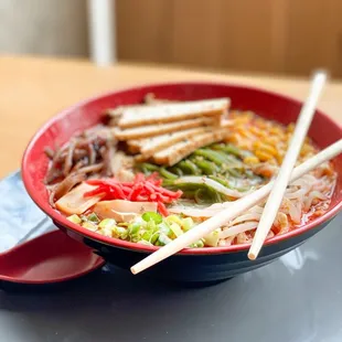 a bowl of ramen with chopsticks