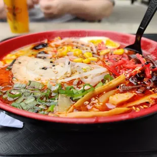 a bowl of ramen with a spoon