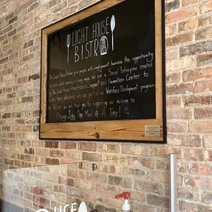 a menu on a brick wall