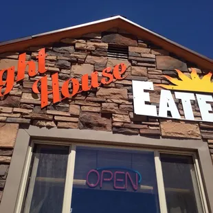 a brick building with a sign that says light house eatery