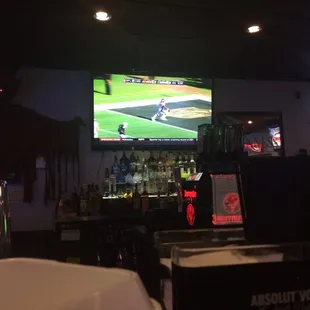 a man watching a baseball game on tv