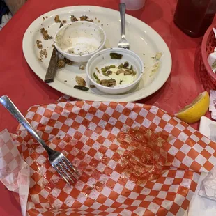 a half eaten pizza and half empty plates