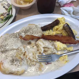 a plate of food with eggs, sausage, and hash browns