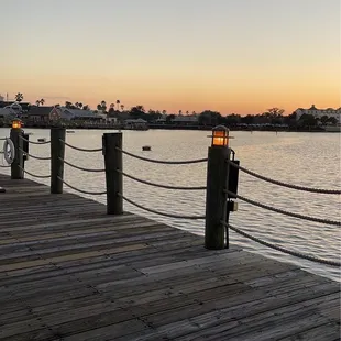 a view of a dock at sunset