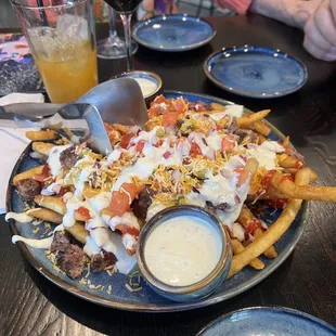 a plate of fries and a glass of wine
