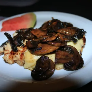 a plate of food with mushrooms and watermelon