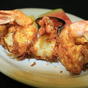 a plate of fried shrimp with a side of watermelon