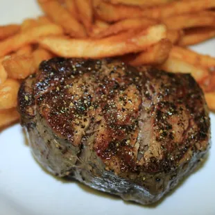 a steak and french fries on a plate