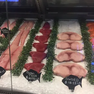 a variety of raw fish in a display case