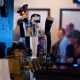 a row of beer taps on a bar