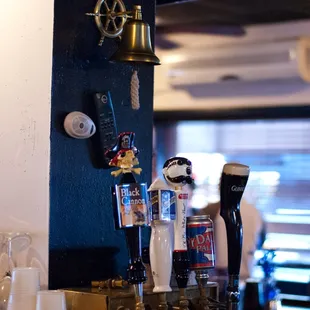 a row of cups on a bar