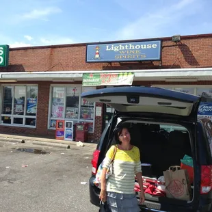 a woman standing in the trunk of a car