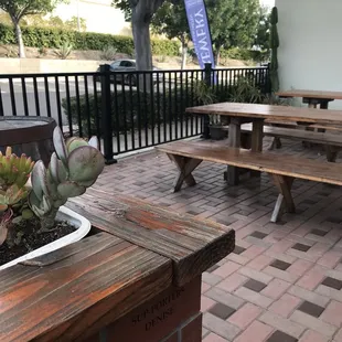 tables and benches on a brick patio