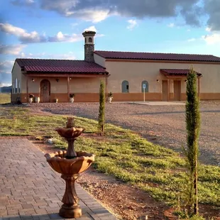 Standing on the Boccie ball court looking at the Tuscan-style winery during sunset.
