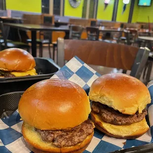 two hamburgers on a tray at a fast food restaurant