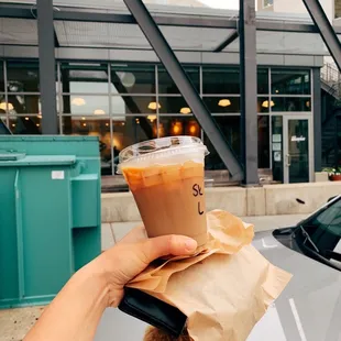 a hand holding a cup of coffee