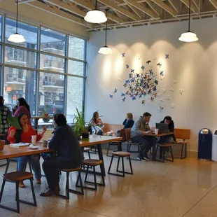 people sitting at tables in a coffee shop