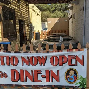 a patio now open sign