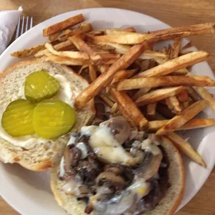 Mushroom Swiss burger with grilled onions and fresh cut fries.