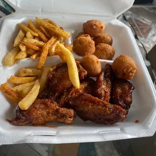 Wet wings with fries and hush puppies