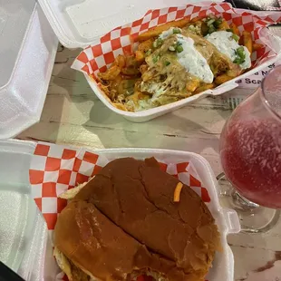 Pulled pork sandwich and loaded fries. Took a bite because I was super hungry.