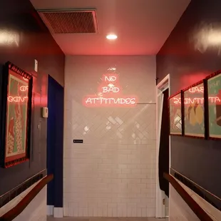 ws a bathroom with a red neon sign